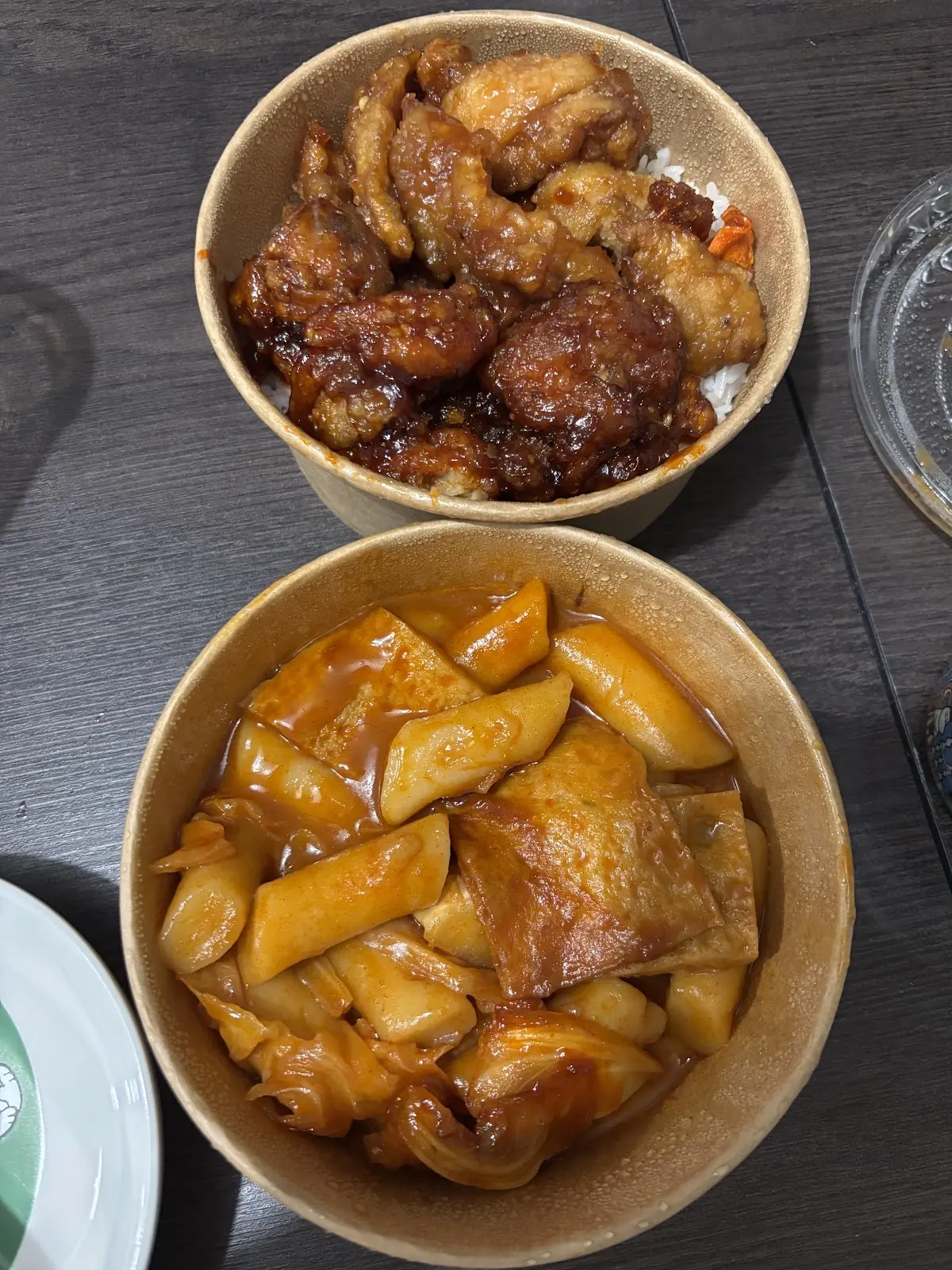 A bowl of soy-glazed Korean fried chicken, cropped square to the top bowl